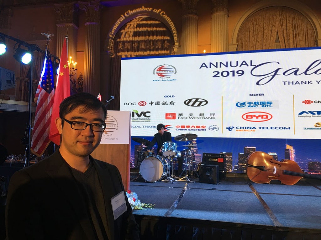 A young man in front of a stage